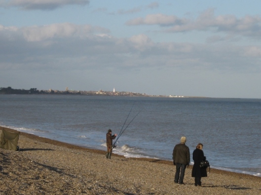 022Fisherman on Dunwich beach with Southwold in the distance (640x480)